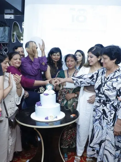 The cake-cutting ceremony at our 18th-anniversary celebration, surrounded by our team and cherished clients.