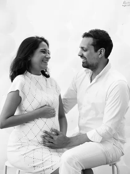 Sharing a happy moment together. This bright and cheerful black and white couple portrait is full of light and genuine smiles.