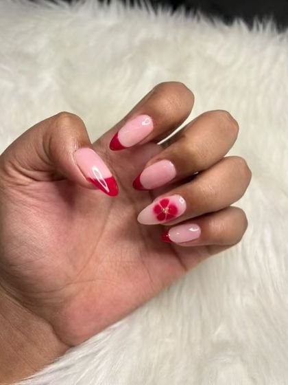 A romantic take on the French manicure, with red tips and a beautiful blooming flower accent nail.