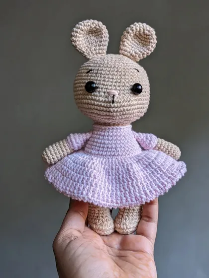 A sweet bunny doll in a pink ballerina dress, perfect for a child's room.