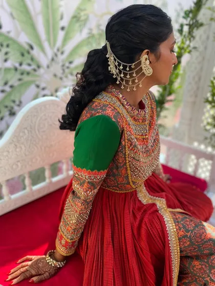 A side profile showing how the dramatic hair accessory and ponytail work together to create a cohesive and stylish look.