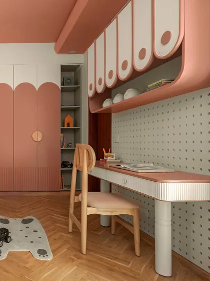 This perspective shows how the study area and storage solutions work together. The custom desk, overhead cabinets, and built-in shelving create a cohesive zone for homework and hobbies, keeping everything neatly organized.