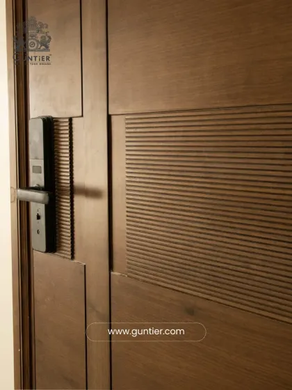 A close-up of a textured veneer door with an integrated smart lock. This shows how I combine modern technology with timeless craftsmanship for both security and style.