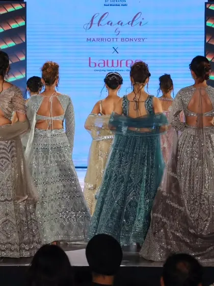 A view from behind the models at the 'Shaadi by Marriott Bonvoy' show, focusing on the beautiful back designs of the blouses and gowns.