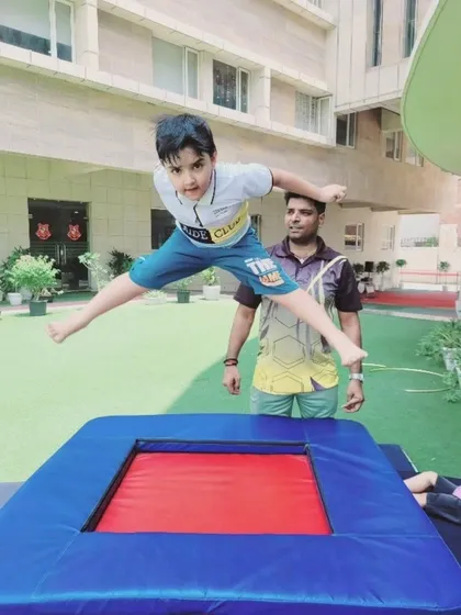We encourage joyful movement and physical development in a safe, supervised environment. Here, a camper experiences the thrill of our gymnastics session, jumping with confidence on a trampoline under the watchful eye of our experienced instructor. This activity is excellent for building coordination and gross motor skills.