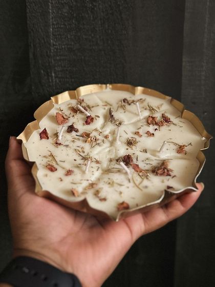 Holding one of my large urli candles to show its size. These make a wonderful centerpiece for a festive table setting or a puja room.