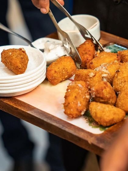 Golden bites of perfection. This tray of crispy coated dahi kebabs is ready to impress your guests, served with delicious dips.