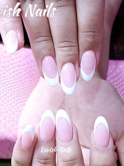 A classic French manicure on perfectly shaped oval nails for a simple, elegant look.