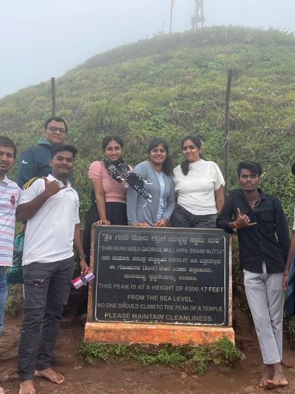 Our trekkers at the Z Point in Kemmangundi, posing by the sign board with the peak in the background.