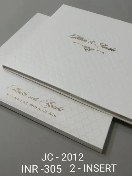 This hardcover invitation features a clean white quilted pattern and elegant gold script. It's a simple yet luxurious choice for a modern, formal wedding.