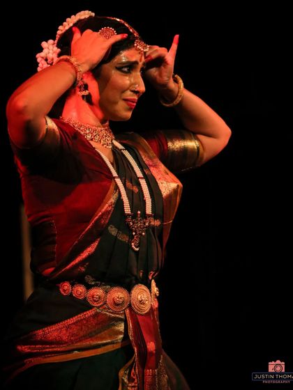 A close-up shot from the 'Soukariyam' performance, highlighting the 'aharya' or adornment. The intricate jewelry and makeup are part of the transformation into the character being portrayed.