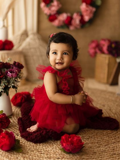A wider view of a similar red dress setup, this time with a rustic, floral background, showing how we can customize the theme.