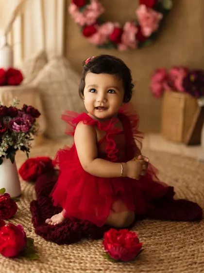 A wider view of a similar red dress setup, this time with a rustic, floral background, showing how we can customize the theme.