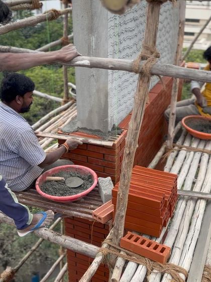 A close-up of a craftsman at work, ensuring each brick is perfectly aligned.