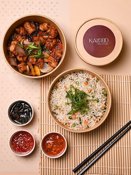 A comforting meal for a cozy night in. This set includes a main dish, fried rice, and three different sauces, all neatly packed and ready to warm you up.