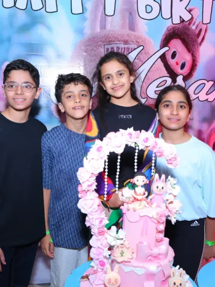 The birthday girl and her friends pose with the beautiful Labubu-themed cake. It's a unique and trendy theme that we can execute perfectly.