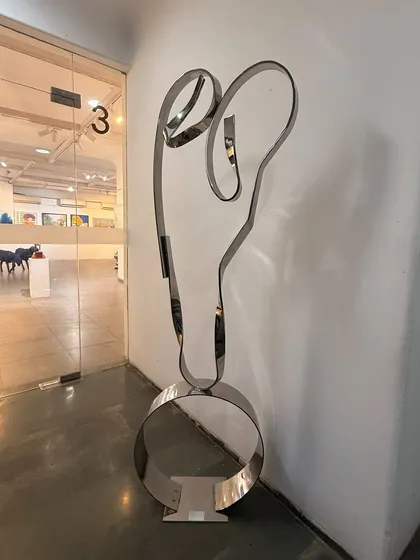 With just a few elegant lines of polished steel, "The Bond" captures the powerful and unconditional love between a mother and child. This freestanding figurative sculpture is an exploration of pure emotion rendered in a strong, resilient material.