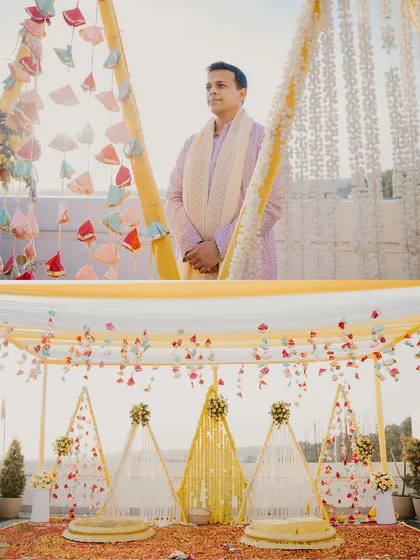 The stunning haldi decor, with marigold strings and colorful tassels creating a festive atmosphere. We always capture the details that make each wedding unique.