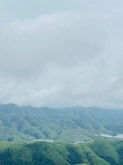 A panoramic view of the rolling hills and Lakya Dam backwaters from the Gangadikal trek.