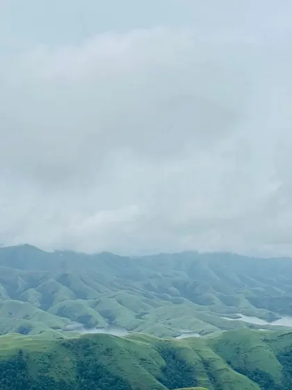 A panoramic view of the rolling hills and Lakya Dam backwaters from the Gangadikal trek.