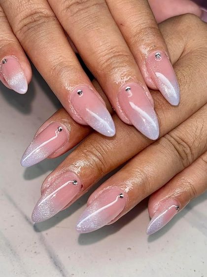 A beautiful ombre set fading from a nude base to a pearly, iridescent tip, accented with tiny rhinestones.