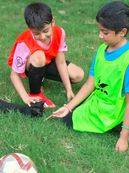 It's not all about drills. Our players take a moment to make a new furry friend, showing the fun and relaxed atmosphere at our academy.