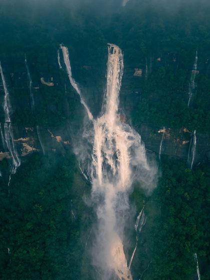 An abstract aerial shot of Phe Phe waterfalls in Meghalaya, showing the power and motion of the water.