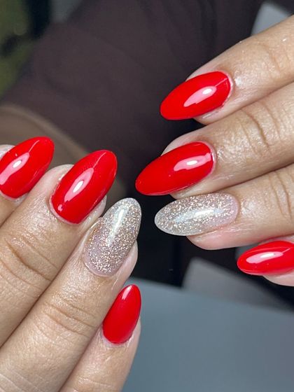 Bright red nails with a sparkling silver accent nail. A classic color combination that's perfect for any celebration, like Teej.
