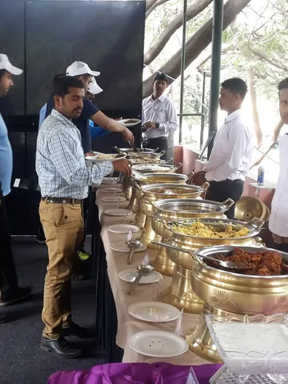 Guests lining up at our buffet during a sports day event. We can cater to all types of outdoor gatherings, ensuring everyone gets a hearty and delicious meal.