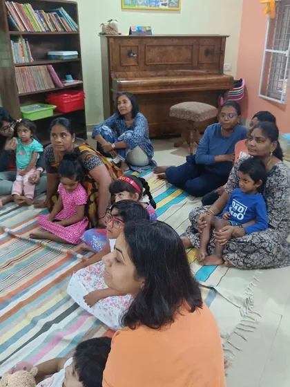A duplicate shot showing the attentive audience during a story about a prince who loves bondas.