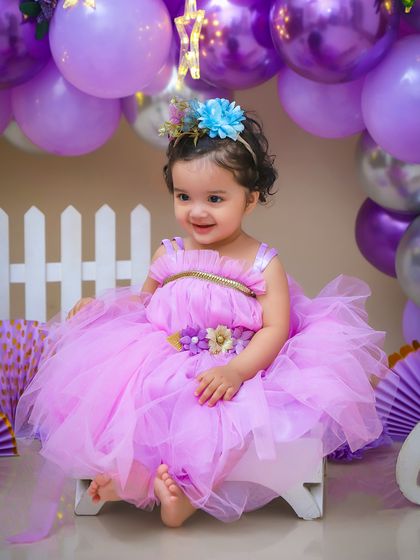 A little princess in a fluffy purple dress, surrounded by matching balloons. I can create birthday setups in any color theme you can imagine.