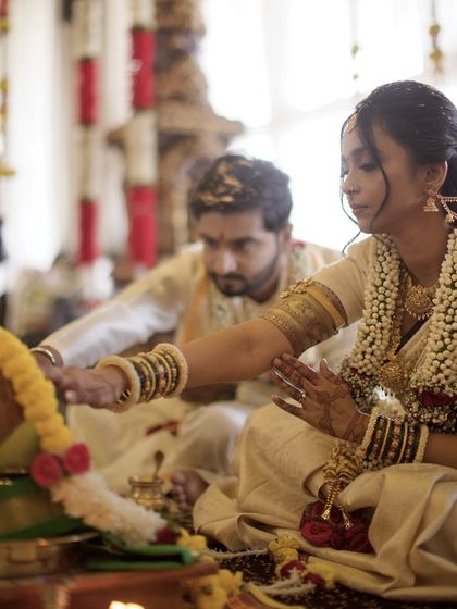 A couple performing a ritual together during their Kannada wedding ceremony. We are experienced in documenting diverse cultural traditions with authenticity.