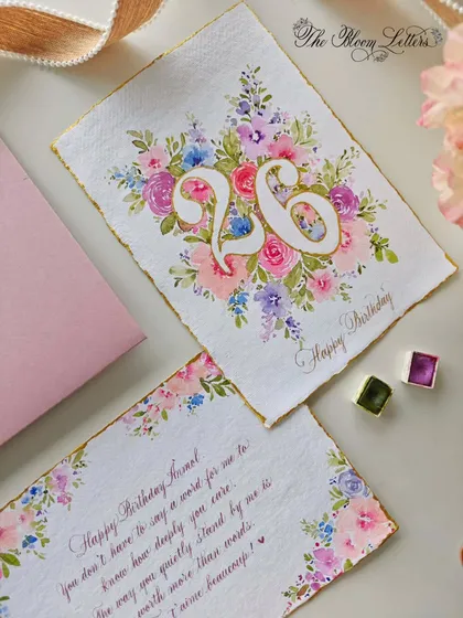 A closer view of the 26th birthday card and the accompanying handwritten note, showcasing the harmony between the watercolor art and the calligraphy.