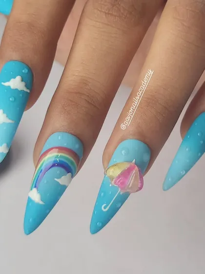 A cheerful and whimsical monsoon-themed set. It features a sky-blue ombre base with hand-painted clouds, a rainbow, and a tiny 3D umbrella, complete with 3D raindrops.