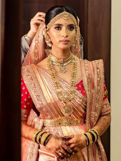 This bride is the epitome of royalty in her stunning silk saree and gold jewelry. Her simple yet elegant mehendi design adds a touch of grace to her regal look.