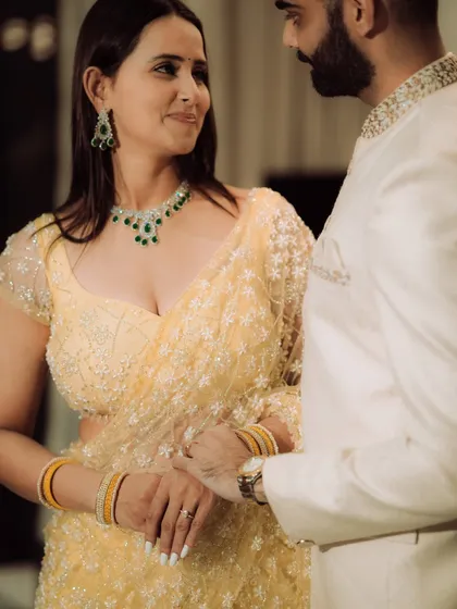 A close-up portrait focusing on the quiet intimacy between the couple. This shot highlights their elegant traditional attire and the gentle connection they share, perfect for an engagement album.