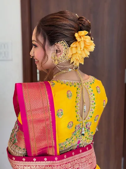 Another angle of the beautiful Khopa hairstyle, showing how the accessories and flowers are placed for a balanced and elegant look.