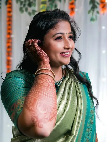 A bride shows off her intricate mehndi design in this lovely portrait.