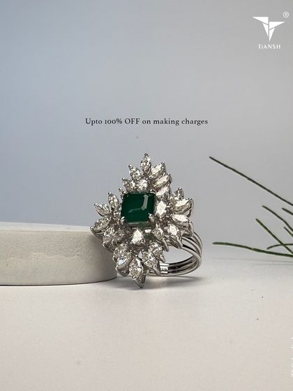 This stunning cocktail ring features a square-cut emerald surrounded by a starburst of marquise diamonds. It's a piece that shines with meaning, stories, and grace.