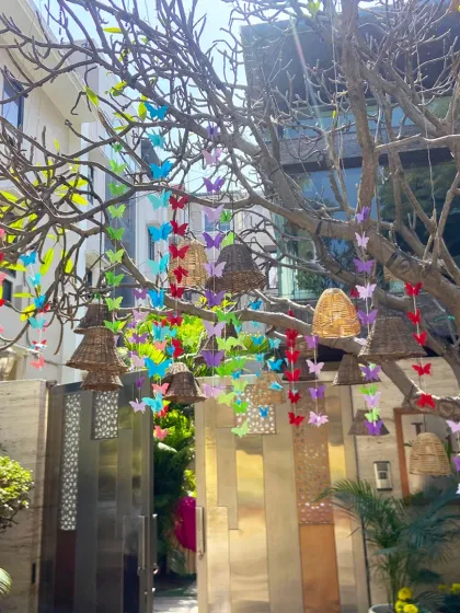 A whimsical entrance for a jungle-themed party. We decorated this tree with colorful butterfly hangings and rustic bells, creating a magical and enchanting welcome for guests.