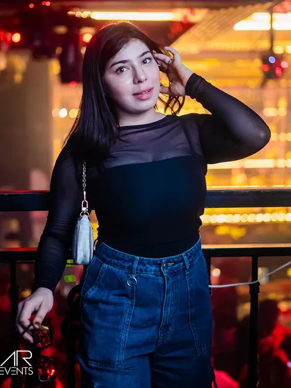 A guest in a stylish black top and jeans.