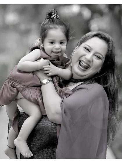 A black and white version of a joyous mother-daughter moment, focusing on their beautiful expressions and laughter.
