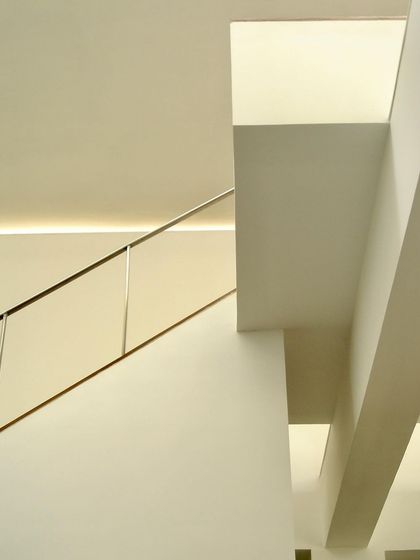 The interior of the Zanav Home design studio, from 2005. The design is an exercise in sculpting space with planes and light, using clean white walls and carefully placed openings to create a minimalist and inspiring work environment.