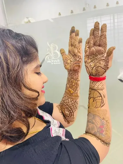 A client admiring her beautiful mehndi design. The portrait work is a special touch.