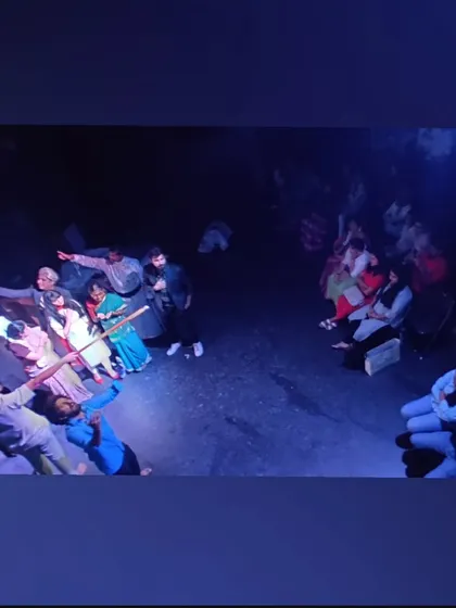 A powerful overhead shot of a student performance, showing the creative use of lighting and the entire stage space.
