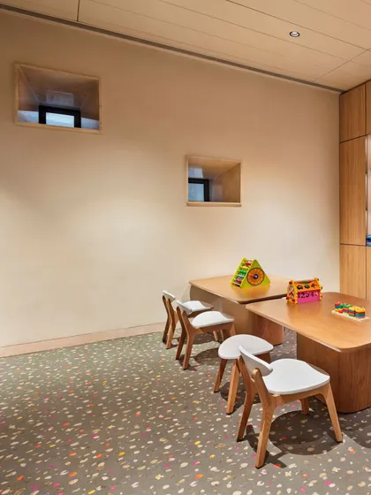 In the kids' play area, we added small, deep-set windows that offer intriguing peek-a-boo views. This thoughtful detail adds a playful element while bringing in natural light, making the space feel more connected to the outside.