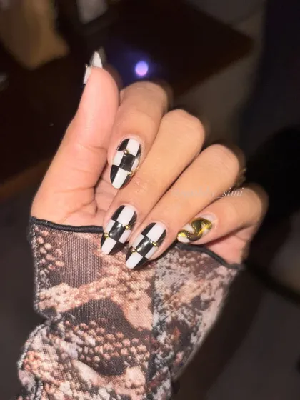 Another shot of the classy and bold checkerboard nails with gold details.