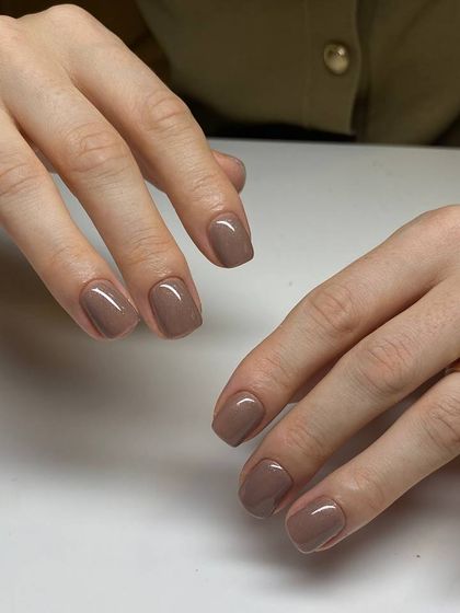 A beautiful example of a classic manicure on short, square nails. The rich brown color is perfect for any season, and the application is flawlessly smooth.