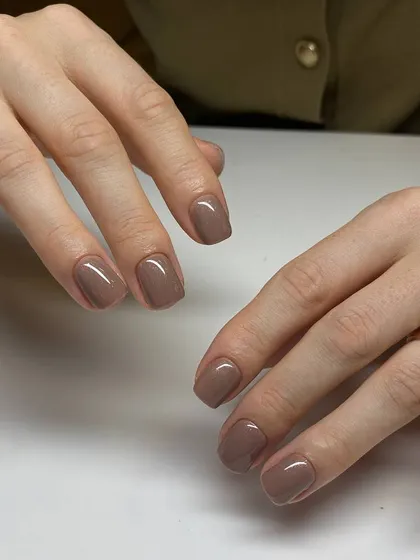 A beautiful example of a classic manicure on short, square nails. The rich brown color is perfect for any season, and the application is flawlessly smooth.