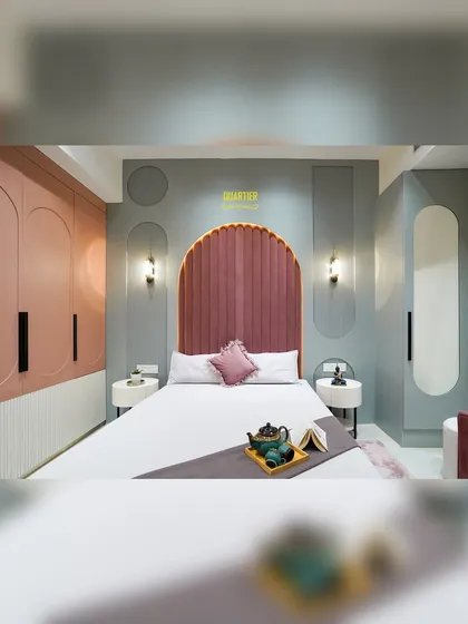 A wider view of the daughter's bedroom, showcasing the cohesive design. The arched headboard, curved wardrobe doors, and oval mirror all work together to create a soft, harmonious, and beautifully designed space.